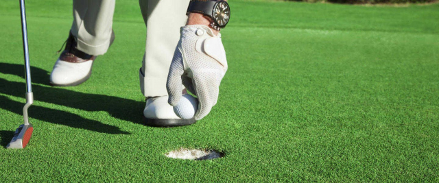 man playing golf on an artificial grass putting green and fake grass golf course