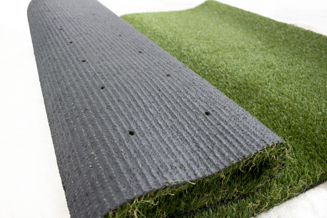 an image to show the latex backing of artificial grass and the drainage holes